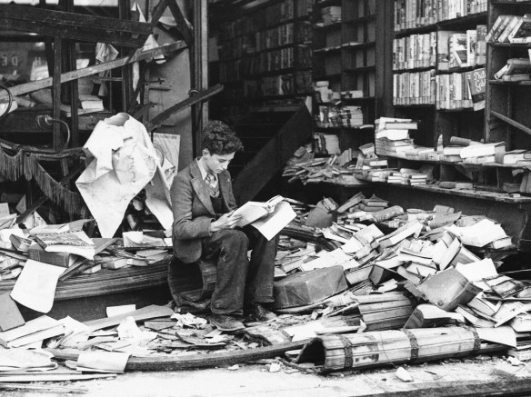 Unknown Photographer, Boy reading in ruined bookshop, London, 1940